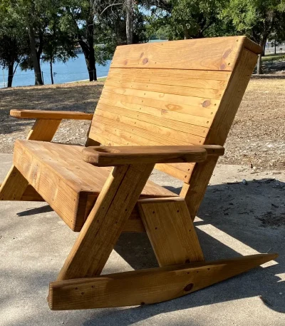 Rustic wooden rocking chair by lake