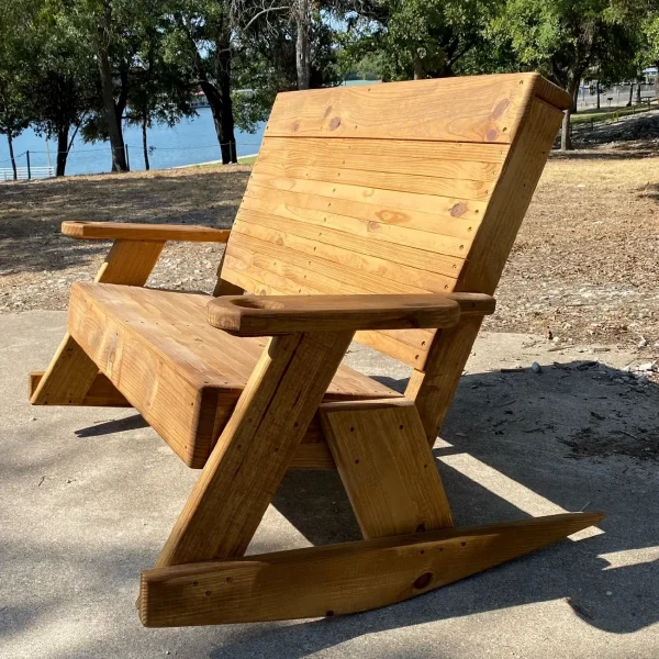 Rustic wooden rocking chair by lake