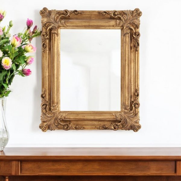 Homeroots - 23" Antiqued Gold Ornate Scroll Framed Accent Mirror - Image 1